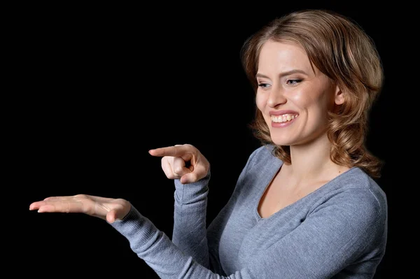 Young woman showing something — Stock Photo, Image