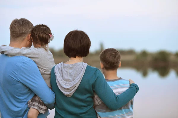 Happy family near lake — Stock Photo, Image