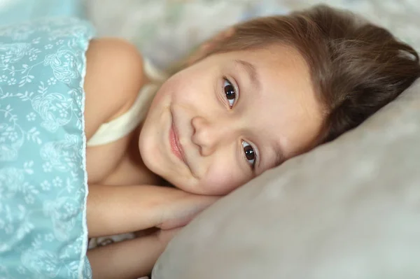 Happy young girl in bed — Stock Photo, Image