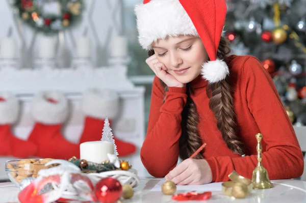 Portrait Happy Girl Santa Hat Preparing Christmas Sitting Table — Stock Photo, Image