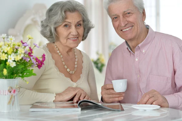 快乐的年长夫妇喝下午茶 阅读杂志 — 图库照片