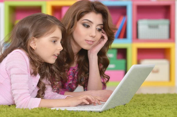 Mujer y niña utilizando el ordenador portátil —  Fotos de Stock