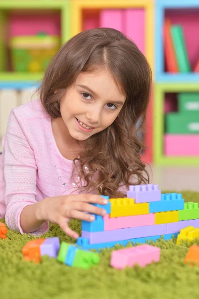 Cute girl playing with plastic blocks Royalty Free Stock Photos