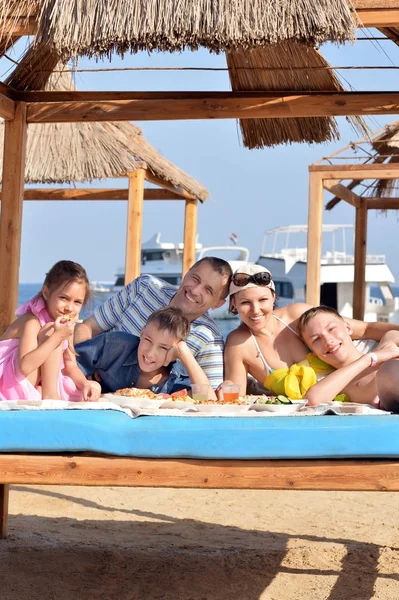 Familia almorzando en la playa — Foto de Stock