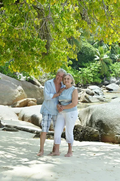 Elderly couple running  on beach — Stock Photo, Image