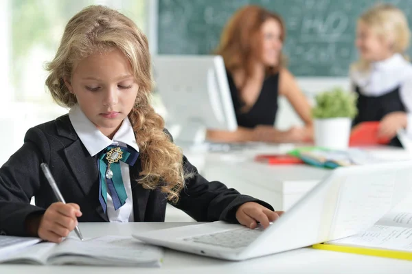 Teacher with two girls at lesson — Stock Photo, Image