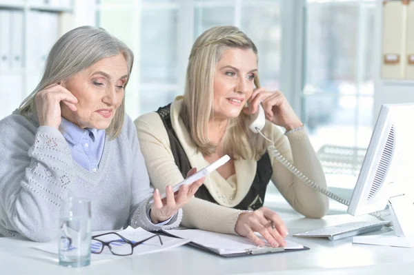 Mujeres que utilizan el ordenador portátil y ordenador — Foto de Stock