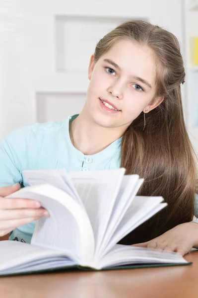 Schattig Schoolmeisje Zit Aan Tafel Thuis Lezen — Stockfoto