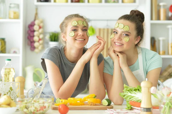 Young women with facial masks — Stock Photo, Image