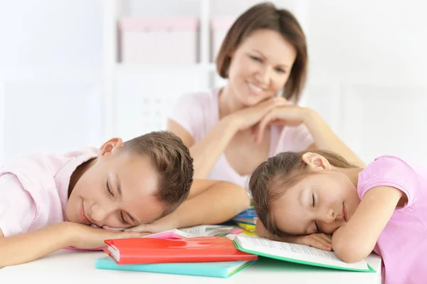 Mother Looking Tired Children Doing Homework Home — Stock Photo, Image