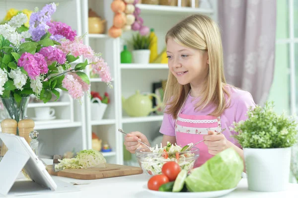 Cute Little Girl Preparing Fresh Salad Kitchen Table Tablet Home — Stock Photo, Image