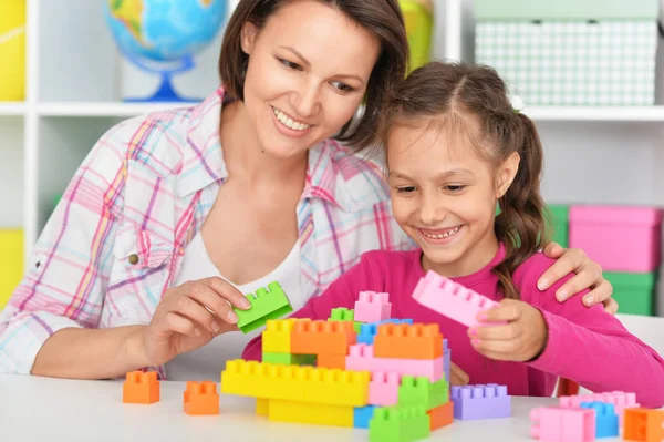 Linda chica jugando con bloques de plástico — Foto de Stock