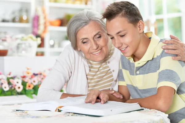 Grandmother and boy reading  together at home