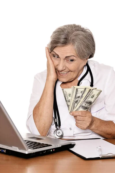 Medico Anziano Seduto Tavola Con Laptop Dollari Mano — Foto Stock