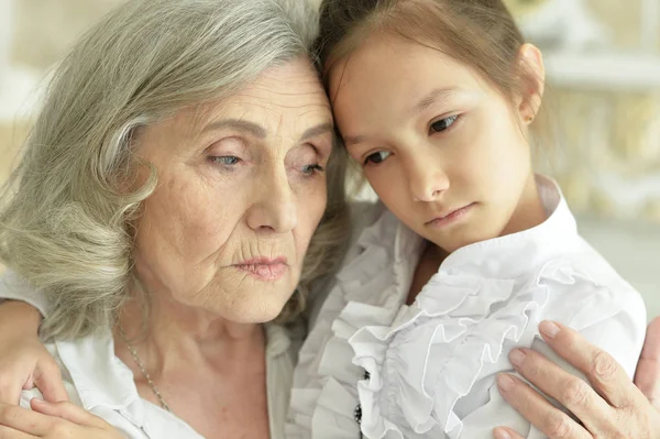 Portrait Sad Grandmother Granddaughter Hugging Home — Stock Photo, Image