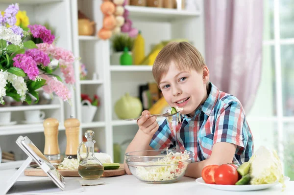 Cute Little Boy Preparing Salad Using Tablet Royalty Free Stock Images