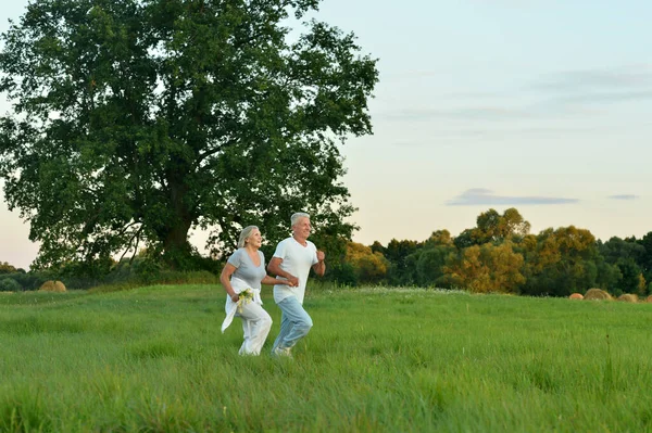 Happy Beautiful Senior Couple Running Summer Field — Stock Photo, Image