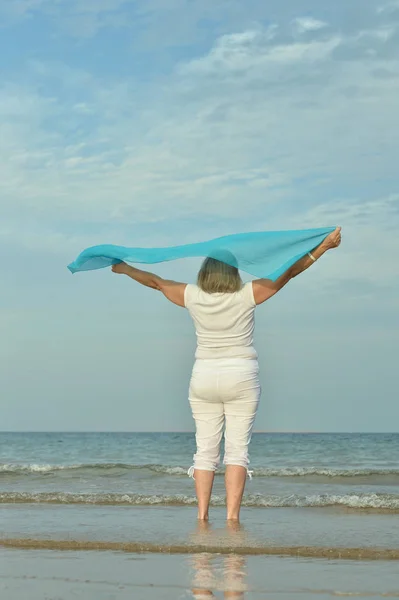 Happy elderly woman on beach — Stock Photo, Image