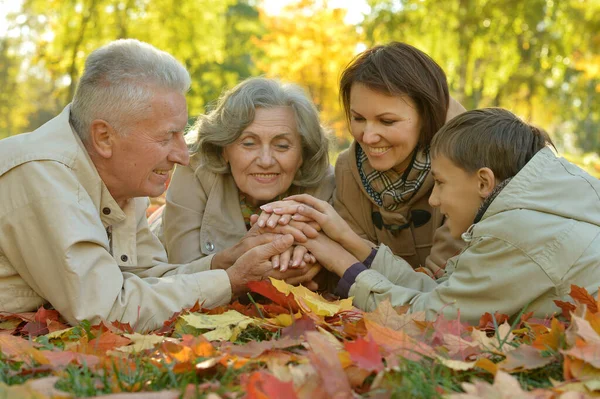 Happy family relaxing in autumn forest — Stock Photo, Image