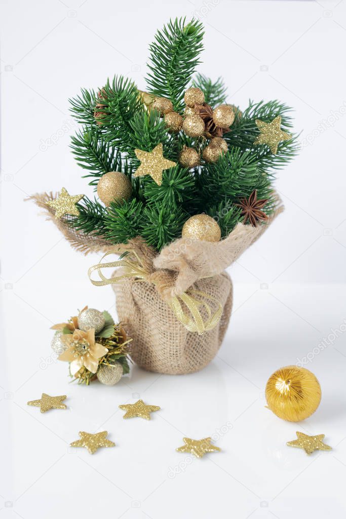 Christmastmie. Golden  decorated artificial Christmas tree isolated on white background. 