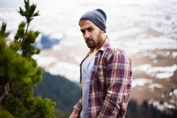 Handsome Lumberjack in mountains 