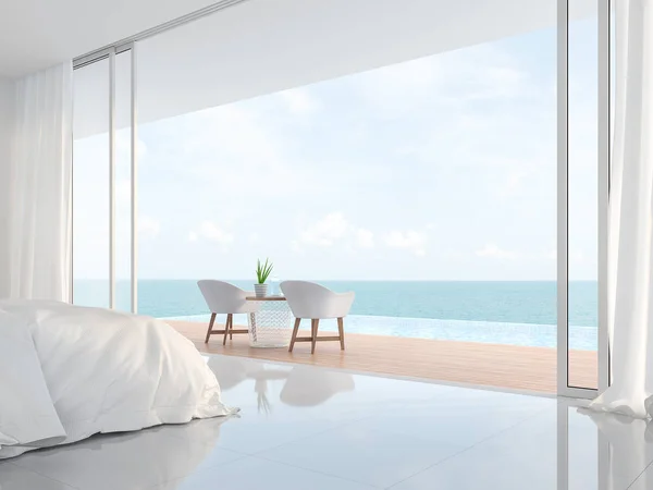 モダンな豪華な白いベッドルームの3Dレンダリング 白いベッドと椅子のミニマリストの建物があります 無限のプールと海の景色を見下ろす大きなオープンスライドドアがあります — ストック写真