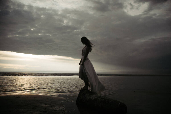  girl in white dress in the sea