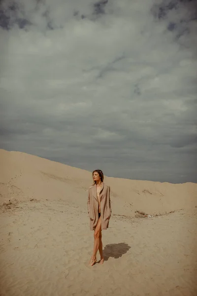 Woman with fit body portrait in desert