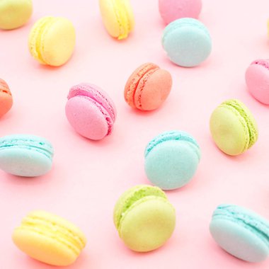 Pembe bir arka plan üzerinde renkli macaroons