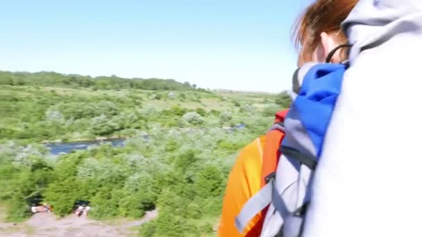 Girl  hiker  tourist with tracking sticks and  backpack  goes up  mountain track. Steadicam shot, Scene 11  4K .3840x2160 — Stock Video