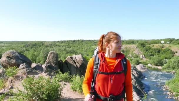 Chica esbelta excursionista turista con palos de seguimiento y la mochila sube por la pista de montaña. Escena 1 4K .3840x2160 — Vídeo de stock