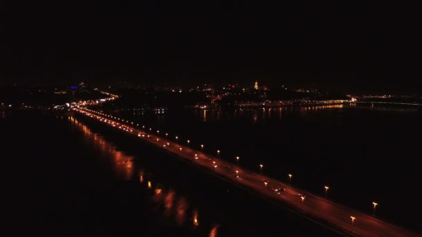 Aérea 4K. Vuelo nocturno sobre puente con coches a través del río — Vídeo de stock