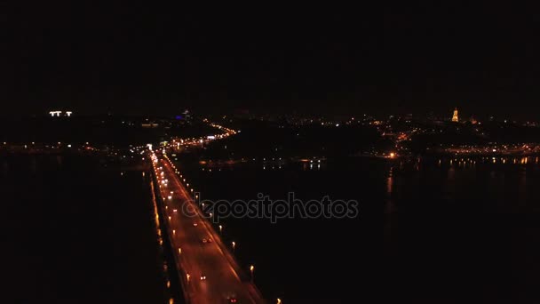 4k luchtfoto. Nachtvlucht over brug met auto's via de rivier — Stockvideo