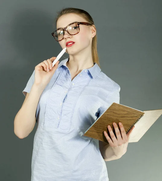 Young woman student or teacher with pen and notebook — Stock Photo, Image