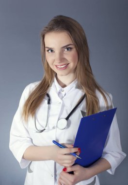 Çekici gülümseyen kadın doktor, hemşire kağıt tablet ve kalem tutan