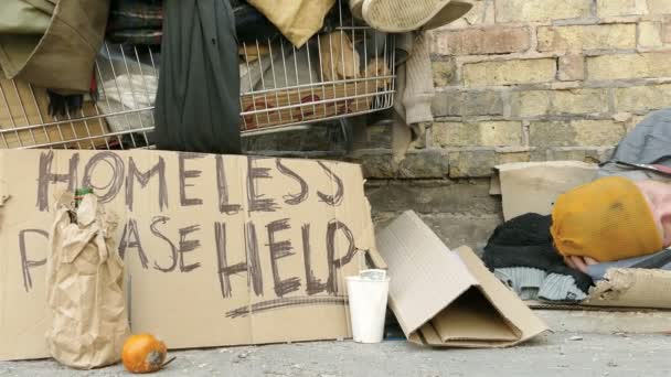 4K. Homeless  man with carriage sleep near wall . Slider shoot — Stock Video