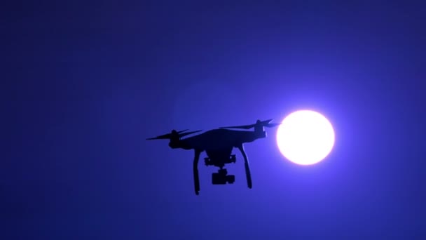 Dron volador rotar delante del cielo nocturno y la luna brillante. Movimiento lento — Vídeo de stock