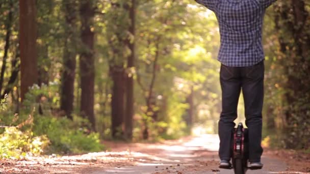 Öröm, a lovaglás. Őszi park road kezét felemelte mono kerék ember. — Stock videók