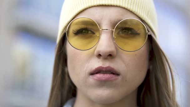 Young Serious Girl Yellow Cap Glasses Stand City Area Close — Stock Video