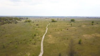 4K Havacılık. Toprak yolun yukarısında, tarlalarda. Doğa çekimi.