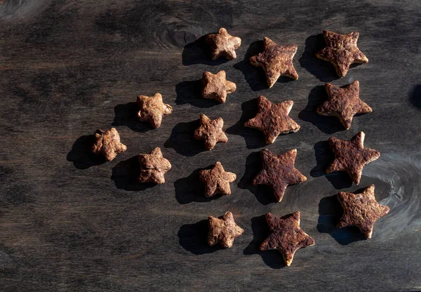 Homemade cookies in the shape of stars. Baking on a wooden background. Simple cooking at home. Star cookies.