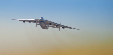 Ukraine, Kyiv - April 23, 2020: Ukrainian AN-225 Antonov cargo plane UR-82060 flies in the sky, transports humanitarian supplies. The largest aircraft in the world clipart