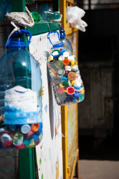 Sorting garbage. Plastic bottle caps. Recycling. The container for collecting plastic. Eco trend. Zero waste.