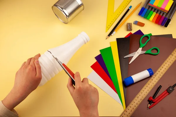 Step 3. Step-by-step instructions on how to make a stand for stationery from recycled materials. Do it yourself. A glass for pencils and pens from a plastic bottle and a can. A fun craft for kids. DIY
