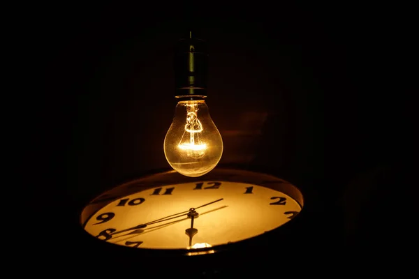 Light bulb and clock — Stock Photo, Image