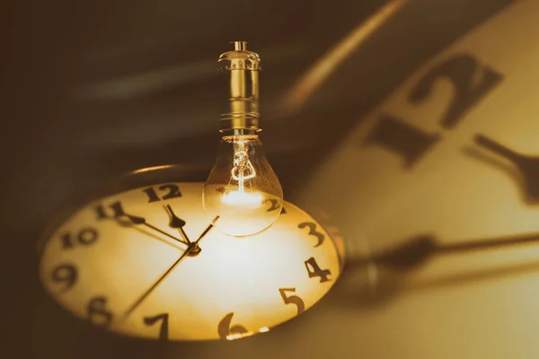 Light bulb and clock — Stock Photo, Image