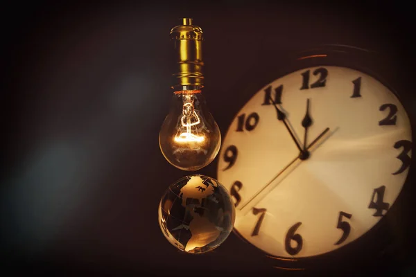 Light bulb, earth and clock