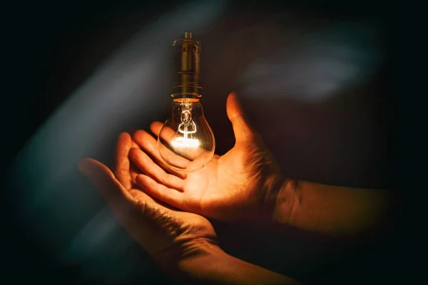 Light bulb and hand Stock Photo