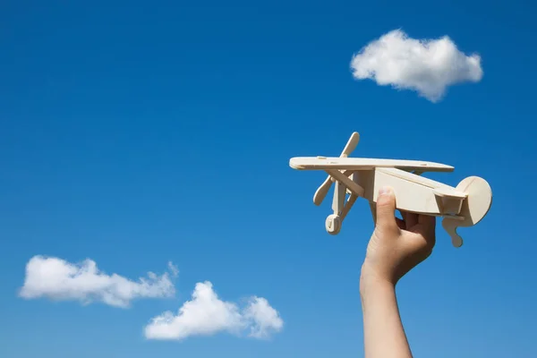 Wooden plane in child hand. — Stock Photo, Image