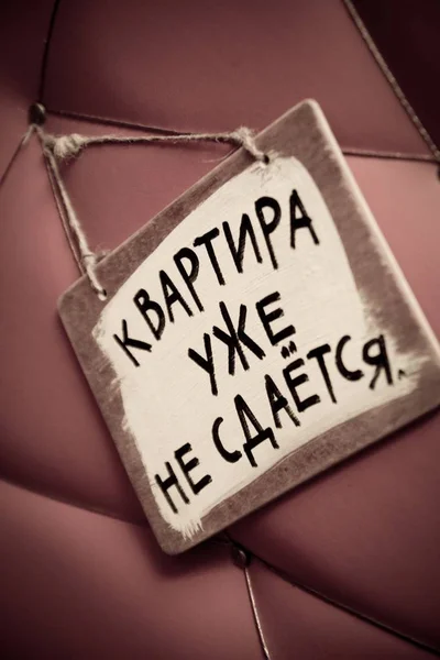 Un cartel en ruso en la puerta de tapicería "el piso no está ya en alquiler". Baja saturación de color para un efecto retro o vintage descolorido —  Fotos de Stock